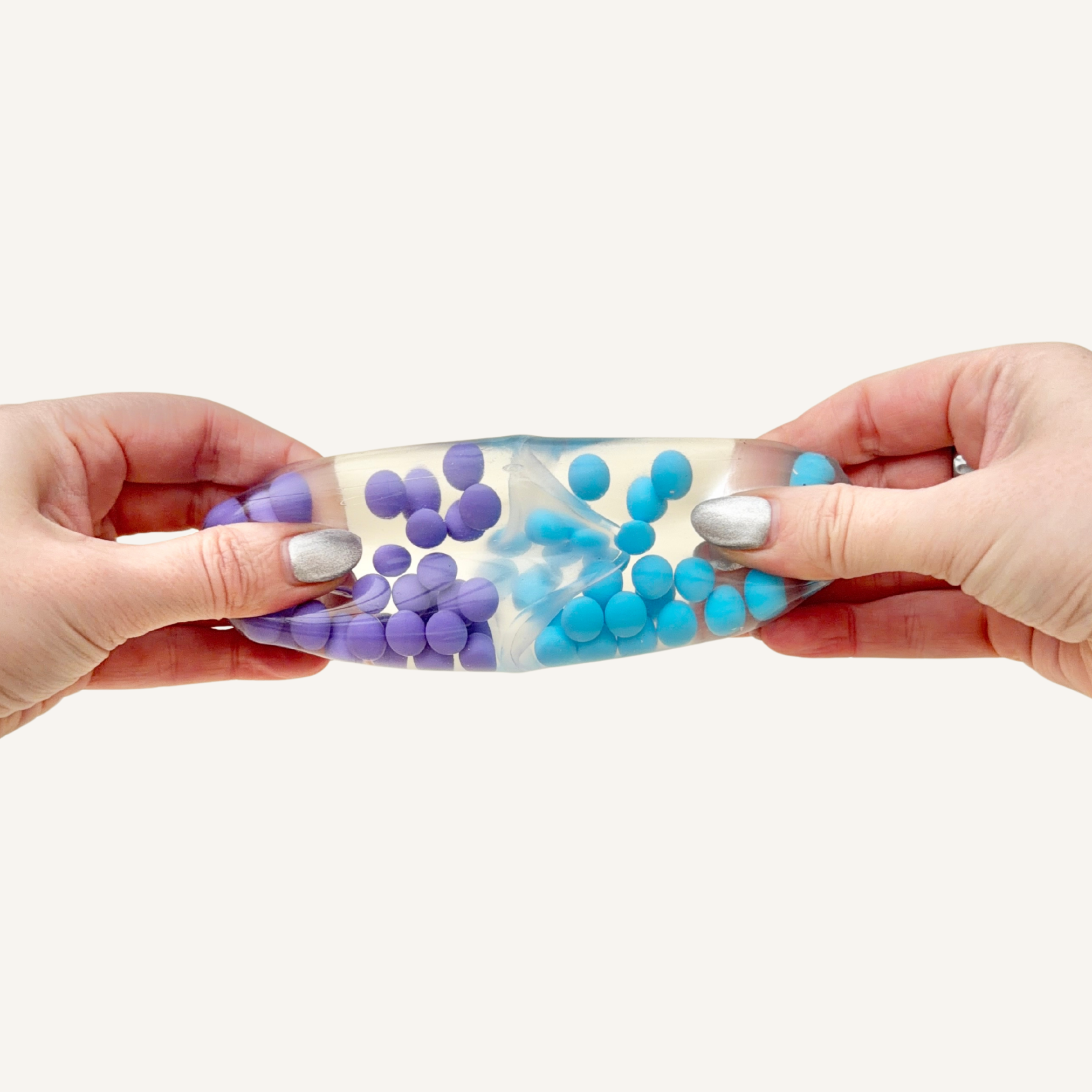 Smooth squish ball fidget with water and firm beads inside, designed for quick squeeze feedback and tactile stimulation.
