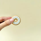 A two-piece magnetic fidget doughnut that flips and spins in hand, providing a satisfying sensory experience.