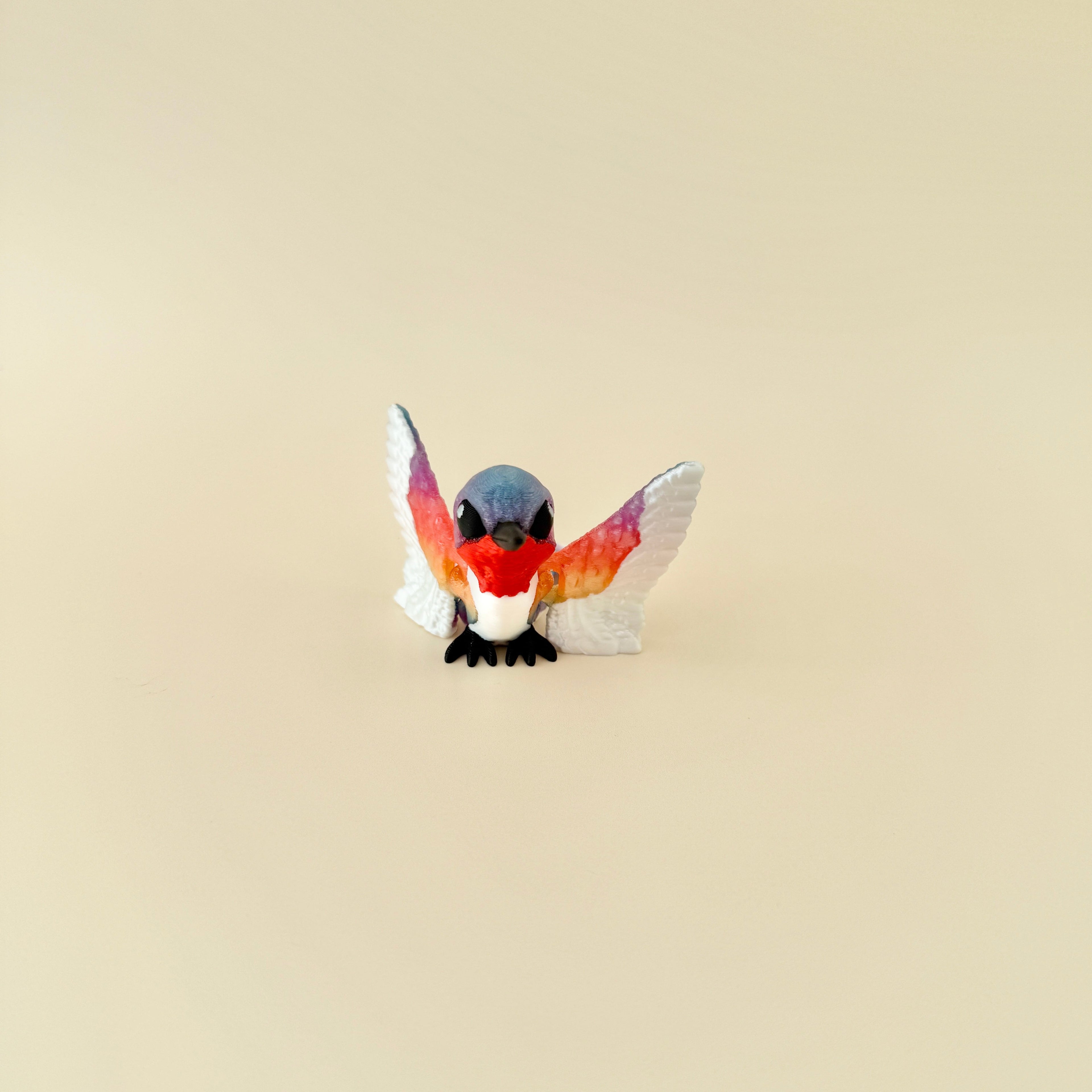 A unique, hand-held bird fidget toy with fully movable wings and a smooth gliding motion.
