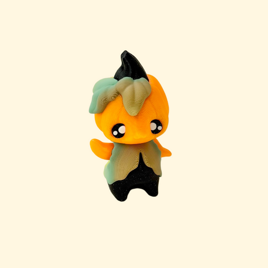 Small articulated pixie figurine with pumpkin theme and tactile leaf details for sensory fidgeting.
