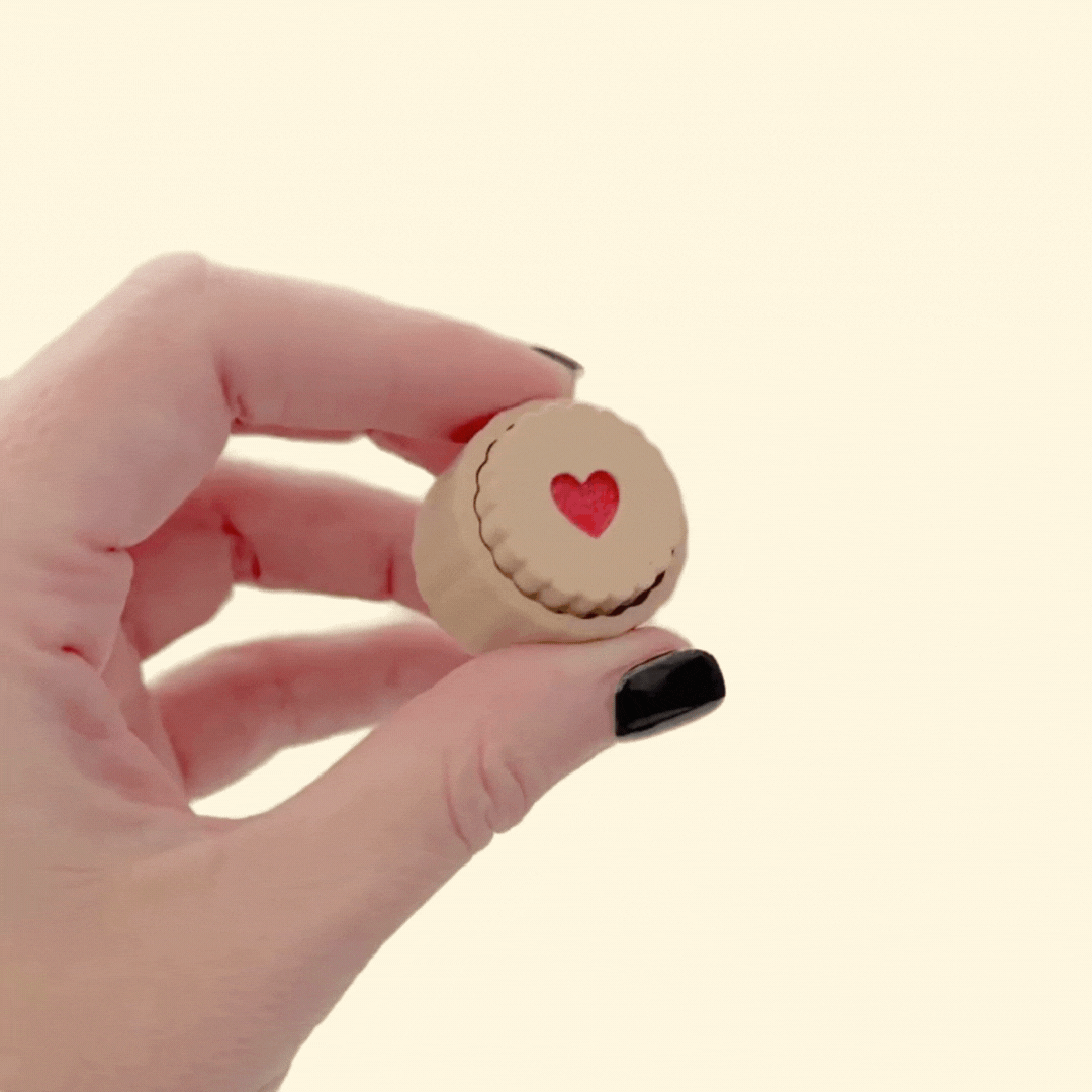 Biscuit style fidget with raised rim and translucent red centre, compact 3 cm size, press action click, optional quiet click upgrade.