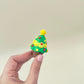 Tactile Christmas tree clicker for sensory seekers; repeatable press-to-reset motion; giftable size.
