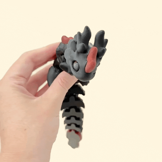 Tactile fidget toy shaped like a dragon with smooth and ridged textures