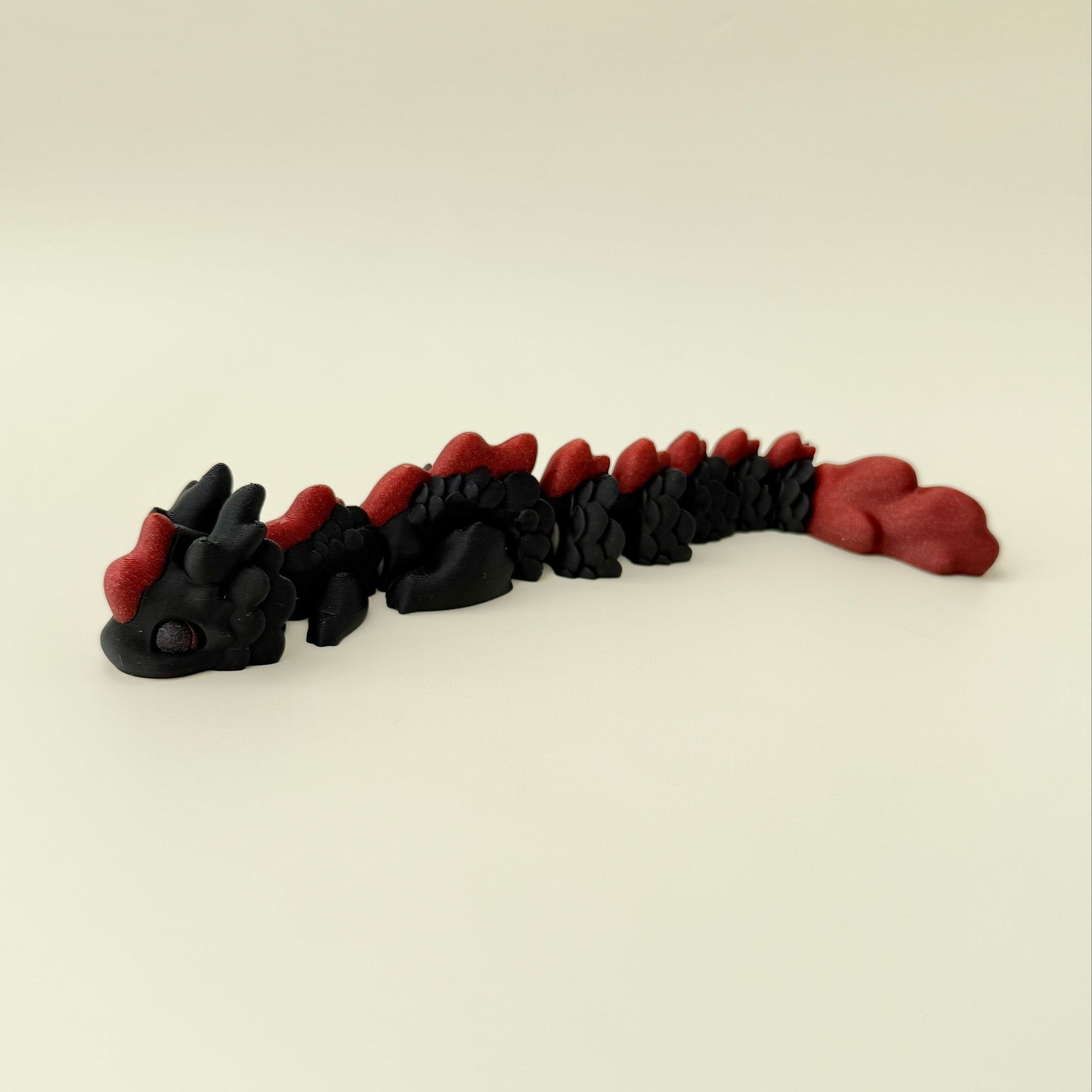 Flexible stim toy with detailed dragon features and sparkling accents