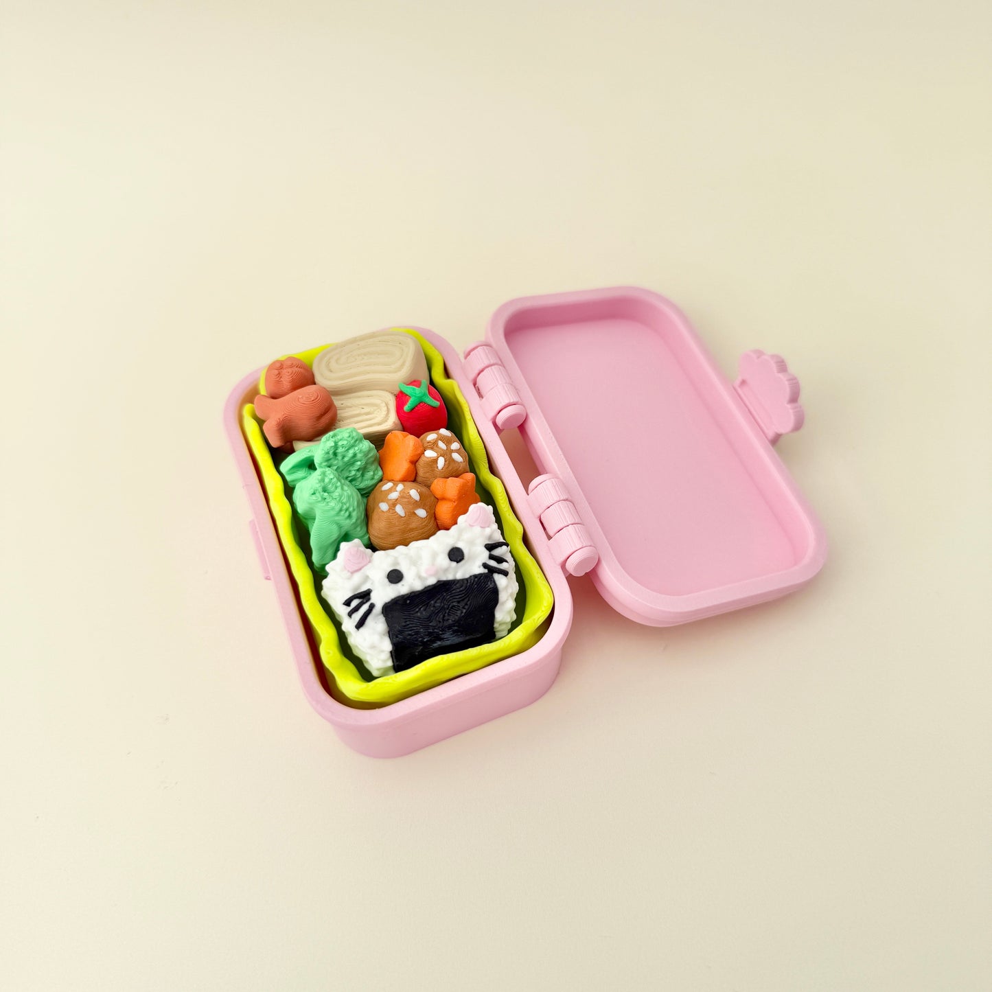Kawaii bento fidget with food-themed buttons; tactile, handheld and easy to carry.