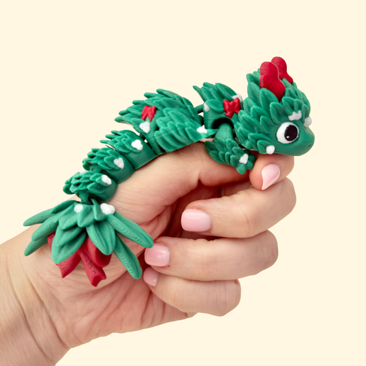 Articulated green dragon covered in mistletoe leaves with white berries.
