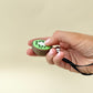 Durable kiwi fidget toy with press-to-click top and tactile surface for everyday stimming.