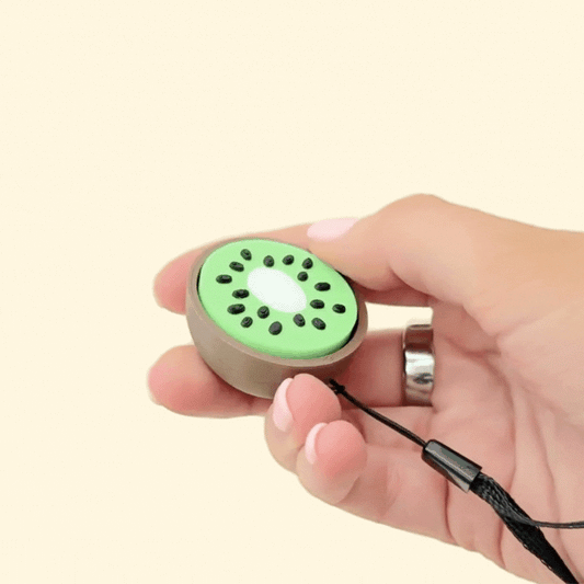 Tactile kiwi clicker with raised seed texture and press action for sensory stimming.
