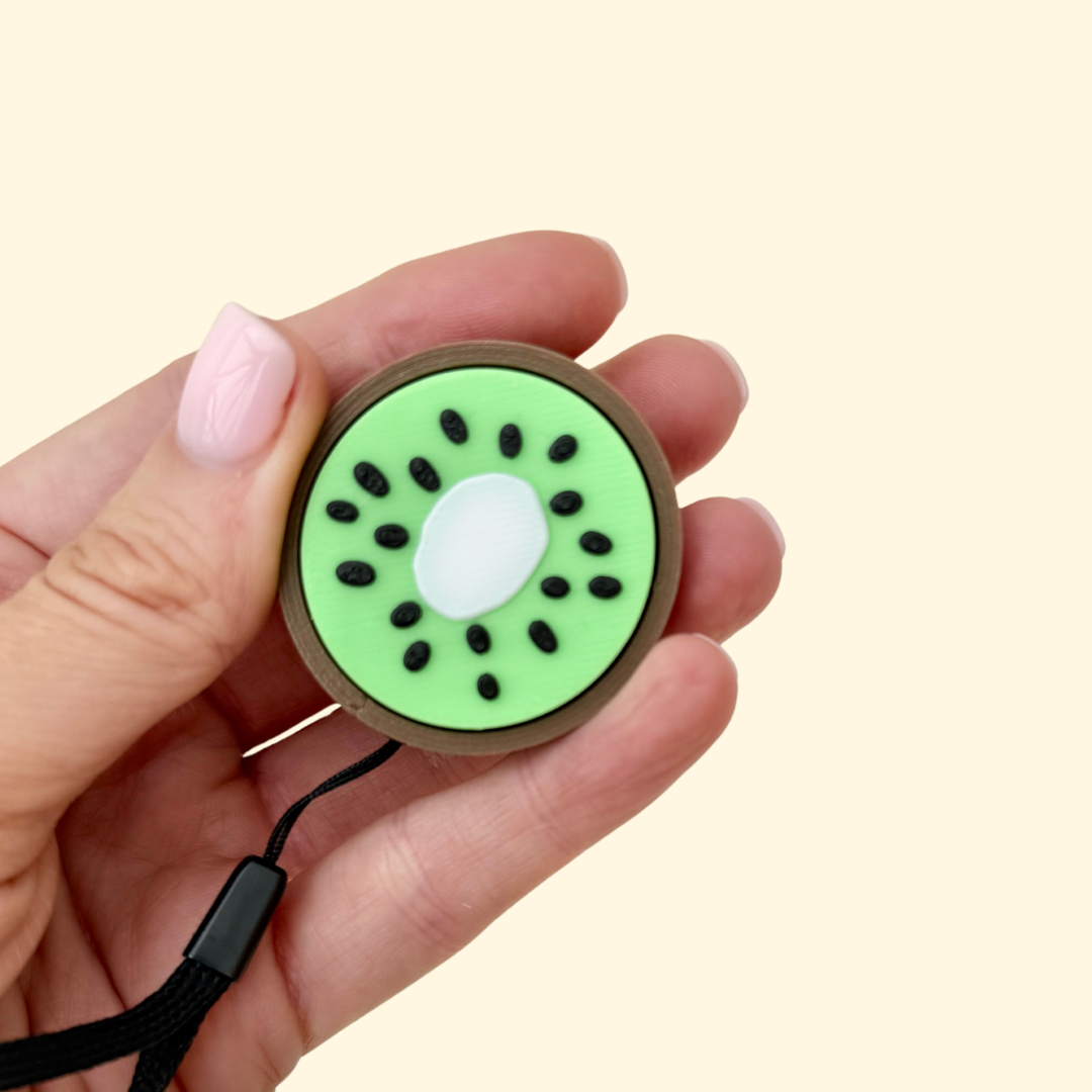 Fruit-themed clicker with wrist strap for bags or lanyards; great for grounding on the go.

