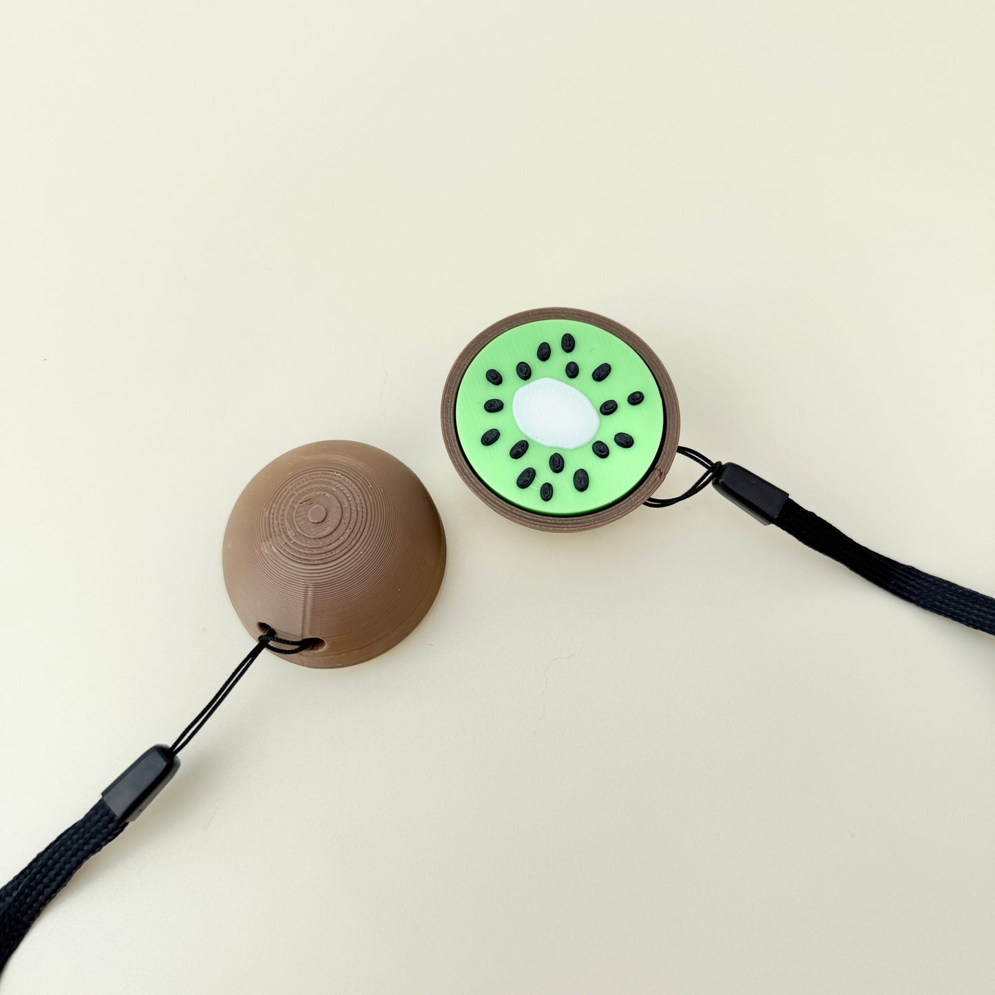 Compact kiwi fidget with raised seeds and satisfying click for focus and relief.
