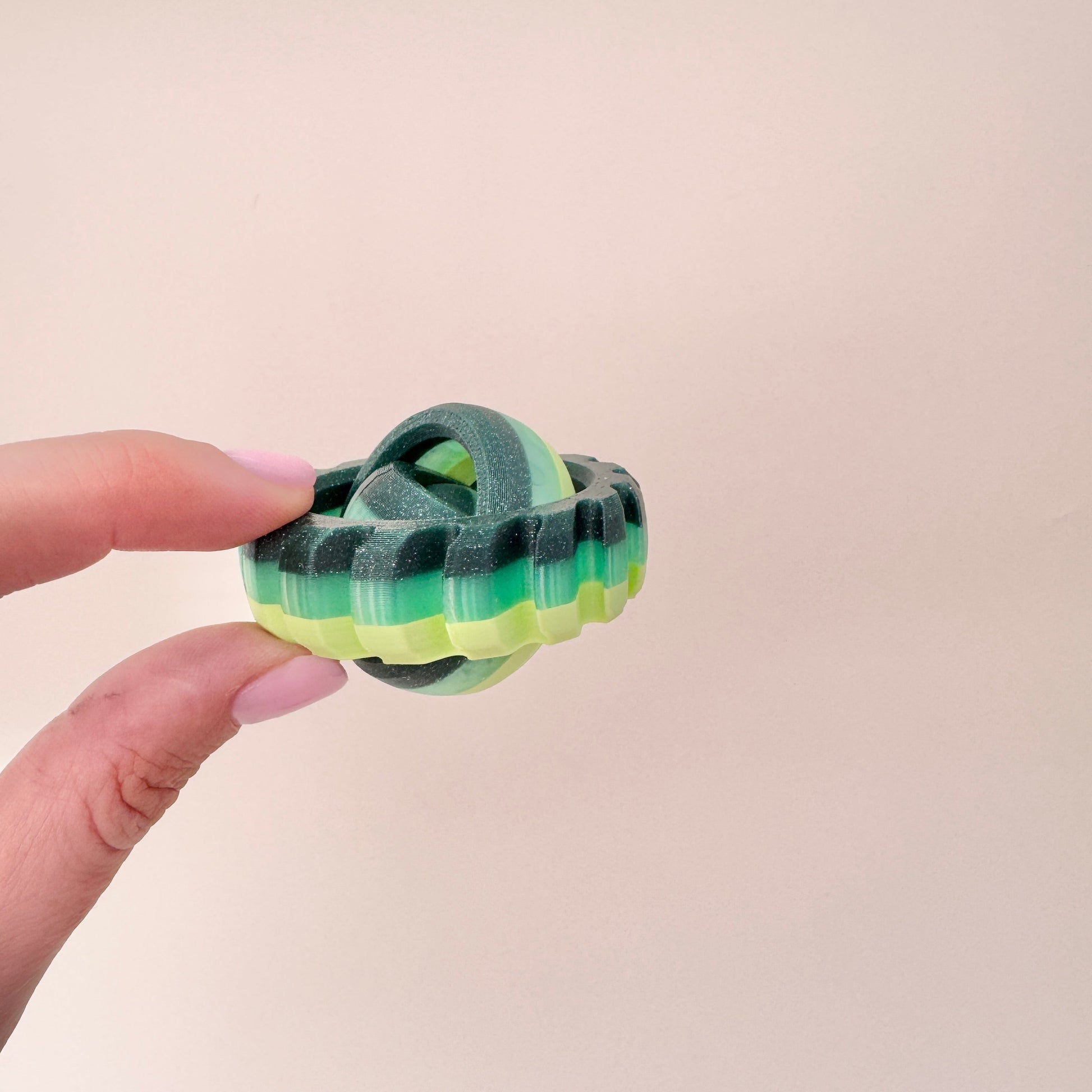 multi-green sensory spinner with rotating centre and tactile rim
