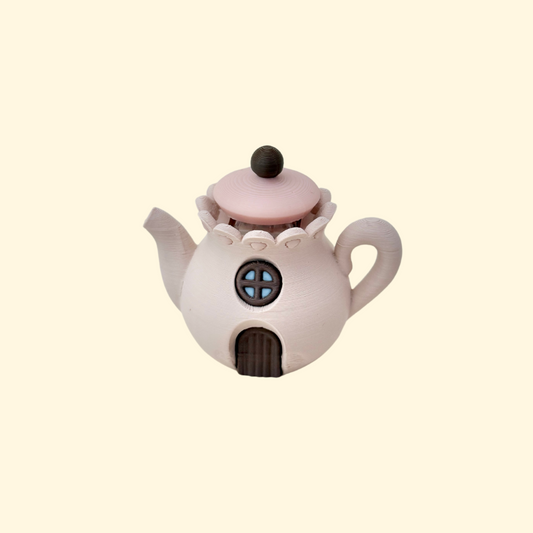 Small 5 cm teapot clicker designed for press-and-release tactile clicking.
