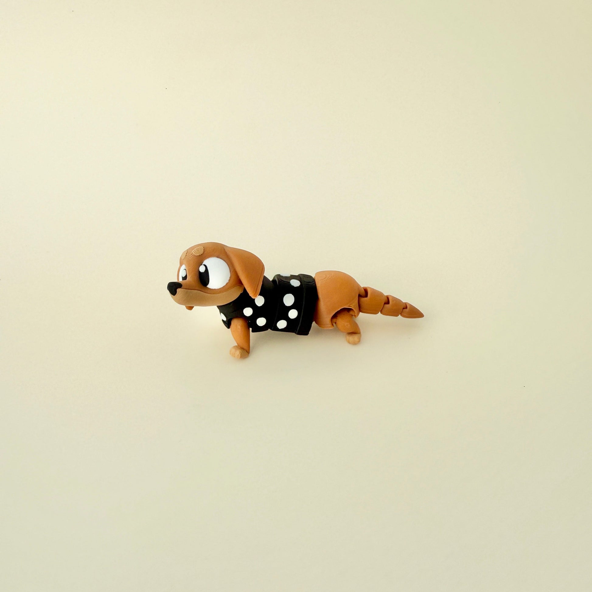  A limited-edition wiggly sausage dog fidget, perfect for anxiety relief and sensory stimulation.