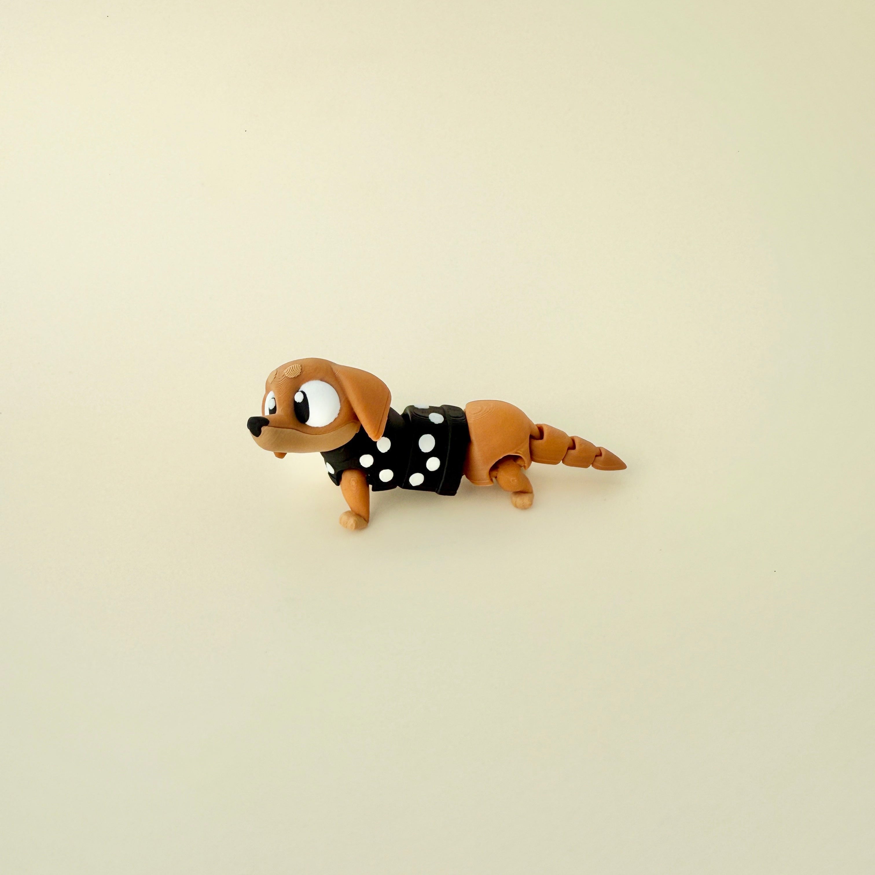  A limited-edition wiggly sausage dog fidget, perfect for anxiety relief and sensory stimulation.