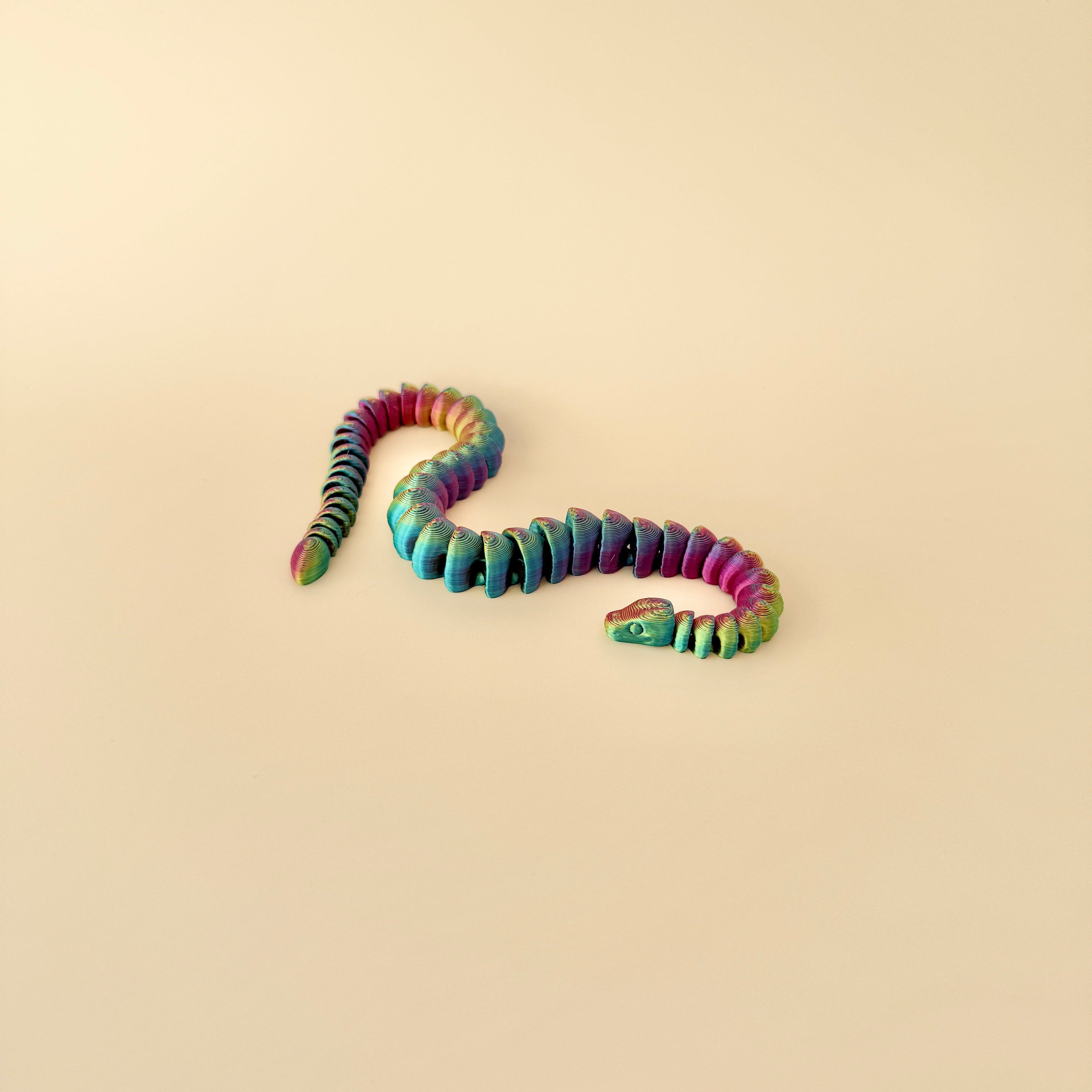 25cm snake fidget toy in a colour-changing filament, offering satisfying sensory engagement and movement.