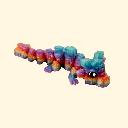 Blocky textured dragon fidget toy with a translucent rainbow finish, ideal for sensory seekers and collectors.