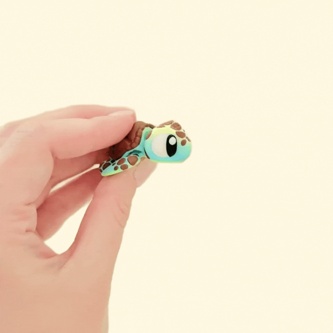 Tactile and portable sea turtle sensory toy with articulated movement and detailed features.
