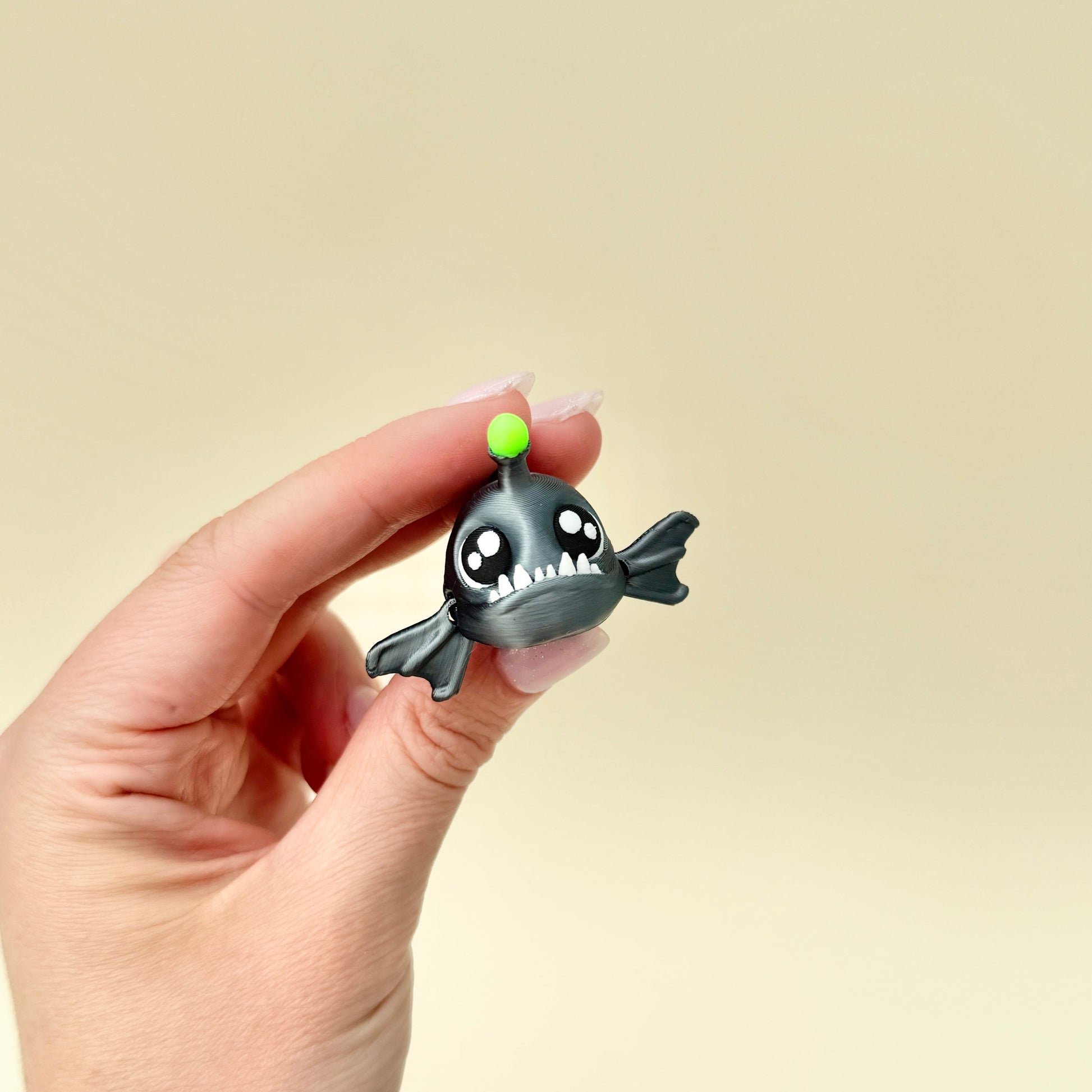 Compact fish-shaped sensory toy with moveable fins and textured features