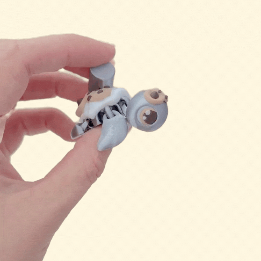 Small tactile turtle with raised chocolate-chip cookies and smooth milk swirl for tracing and fidgeting.
