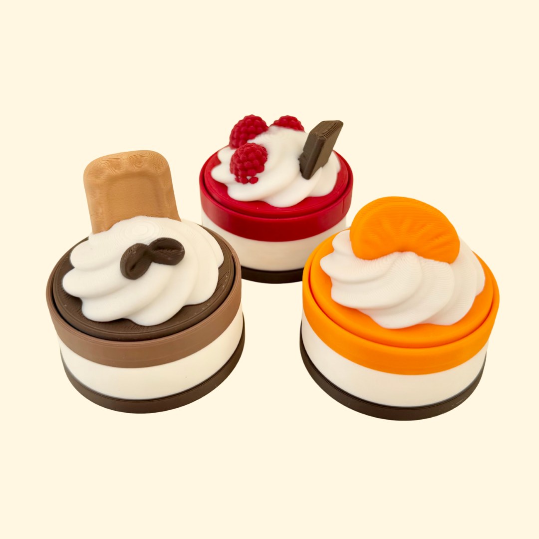 3D printed mini cake clicker fidget with tactile detail and a press-down click, pocket-sized and giftable
