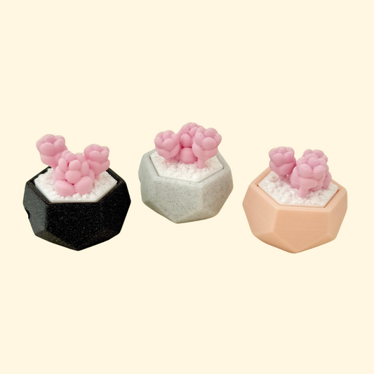 Small plant pot-shaped fidget with a pressable succulent top and silver keyring attachment.