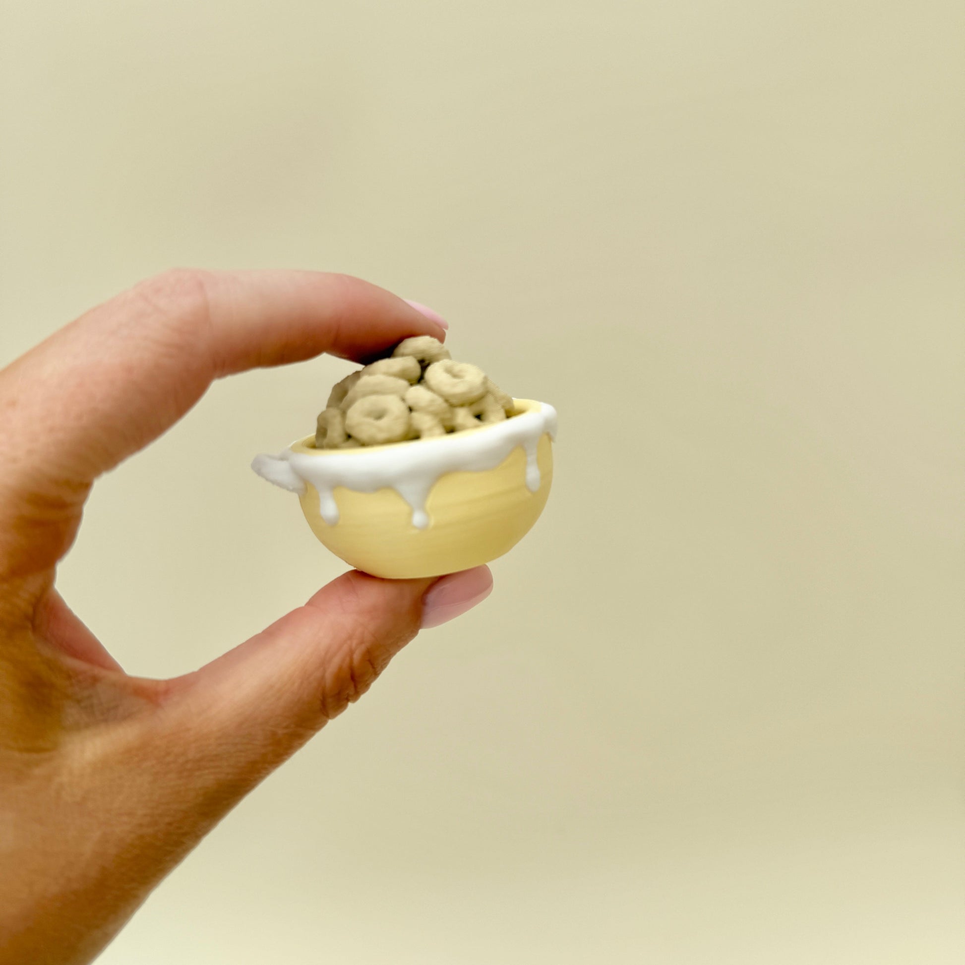 Palm-size 4 cm clicker with raised cereal textures for tactile feedback.
