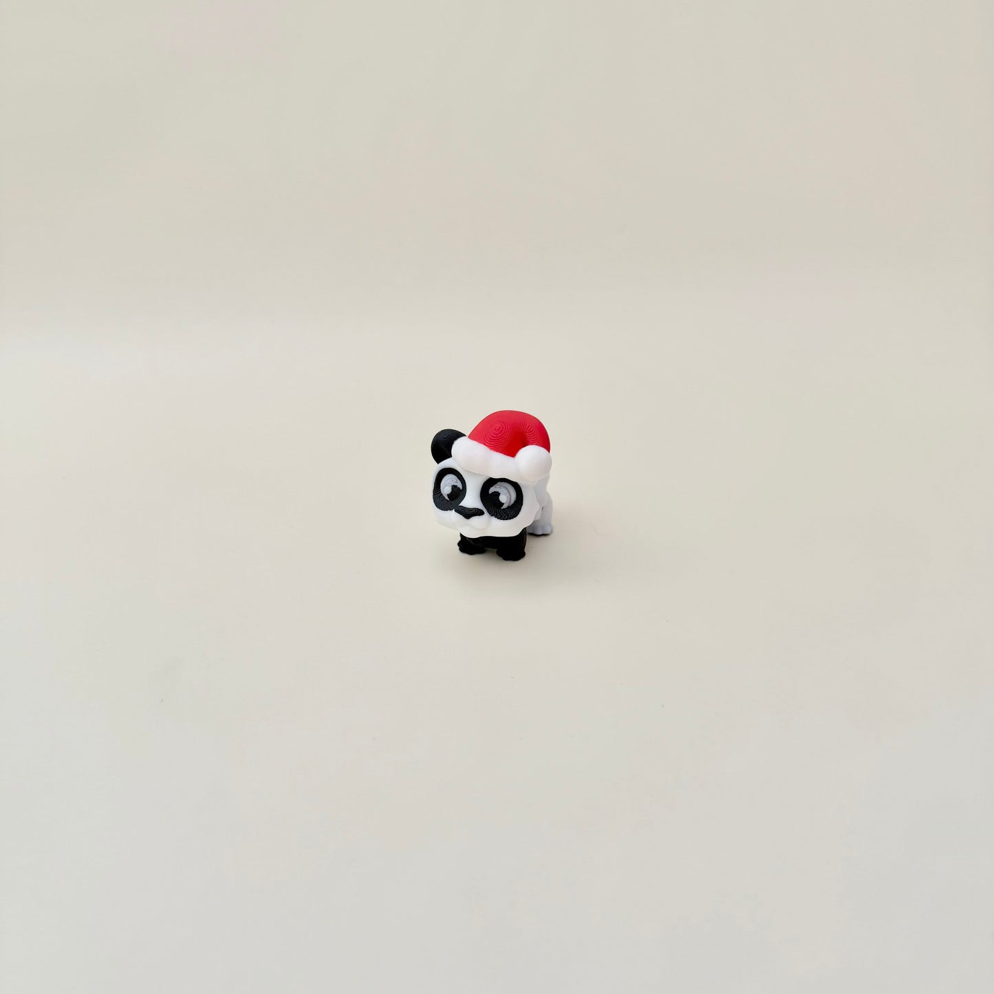 Small festive panda figure with moving parts for quiet hand fidgets.
