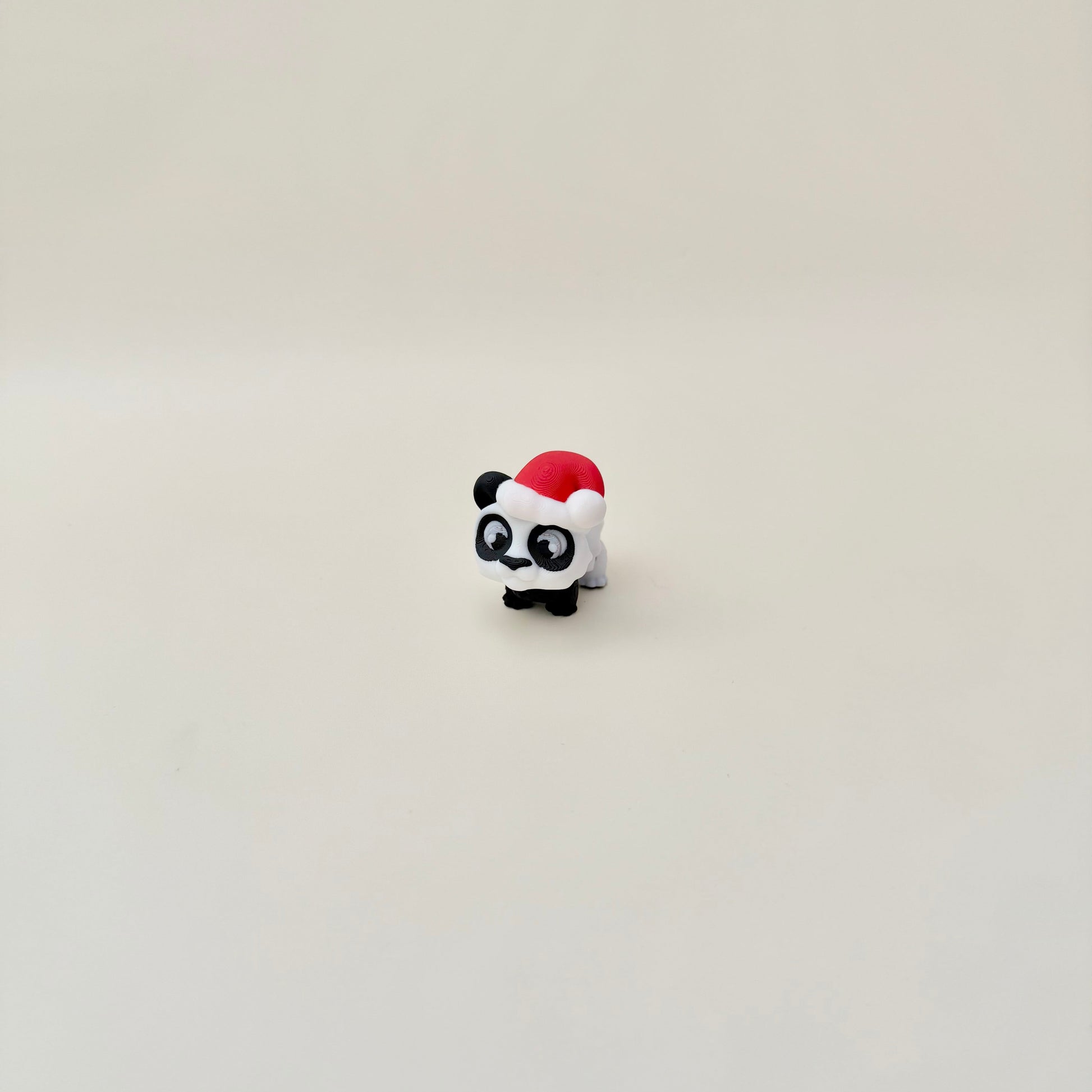 Small festive panda figure with moving parts for quiet hand fidgets.

