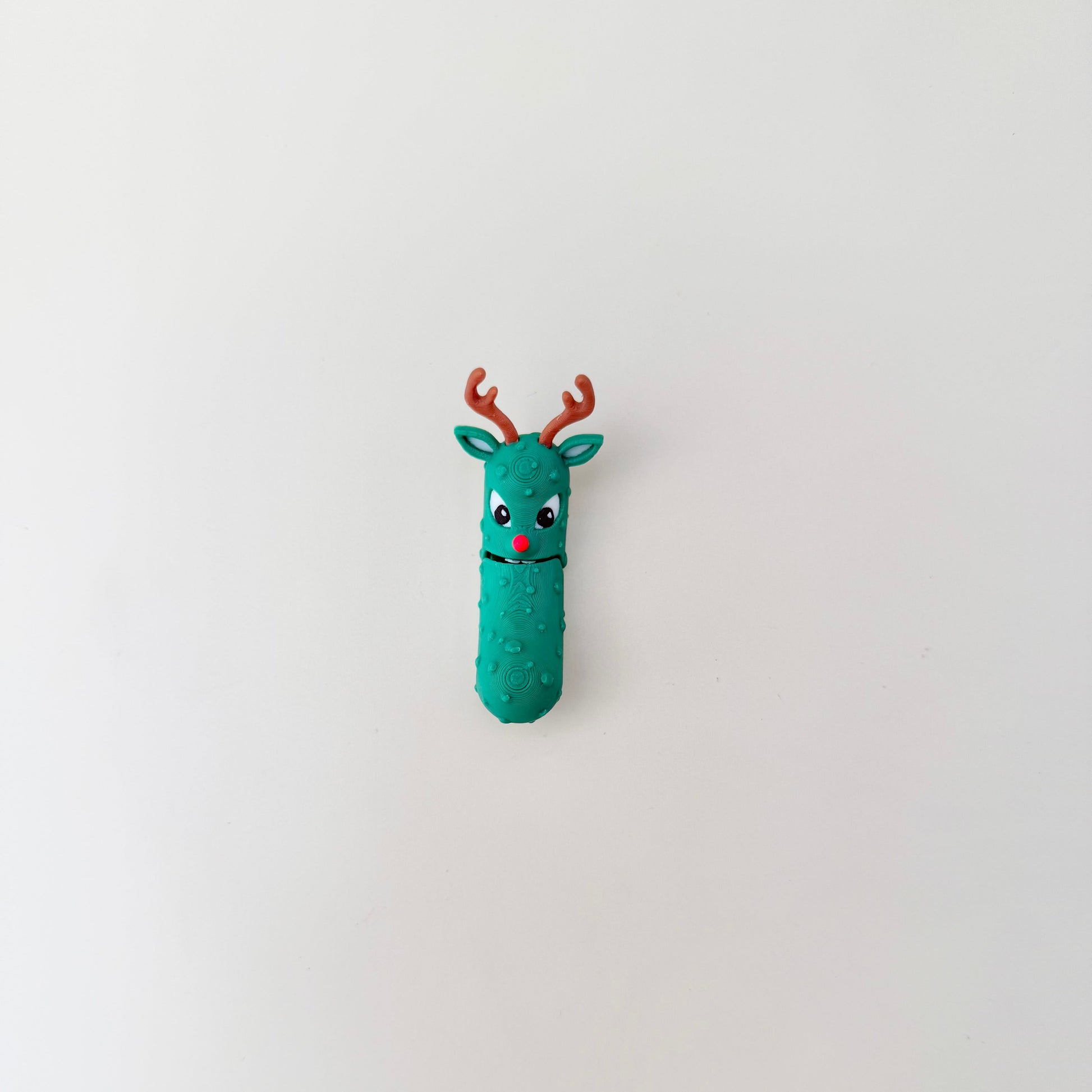 A quirky pickle figure whose mouth opens and closes with movement, offering tactile feedback.
