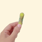 A small handheld pickle with an opening mouth that reacts to movement, designed for playful sensory use.
