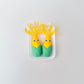 Palm-size corn with a hinged bite that reveals teeth and a tongue for playful stimming.
