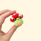 clicker-style articulated fidget creature with textured hat and smooth body
