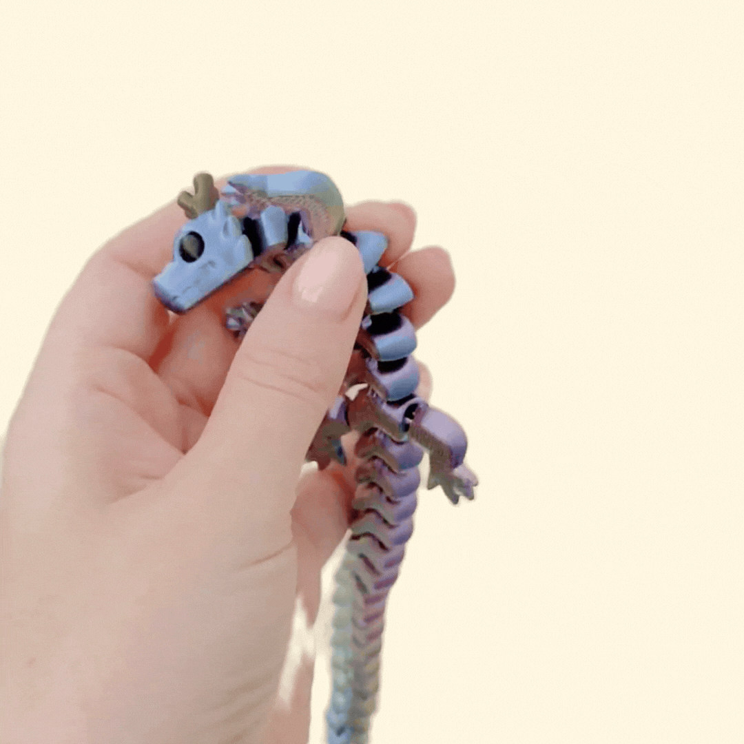 Flexible dragon fiddle fidget with clicky jointed motion for repetitive hand movement and grounding input.
