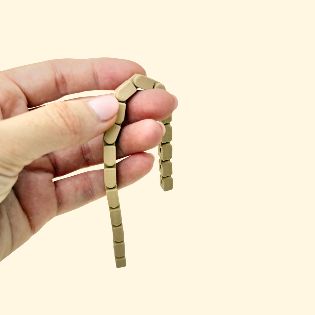 Two flexible stim toys in nude and bright colours, designed for silent finger fidgeting.