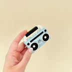 3D printed clicker toy inspired by retro boomboxes, with added sensory texture.