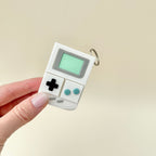 Classic fidget toy shaped like a handheld gaming system with clicker buttons.