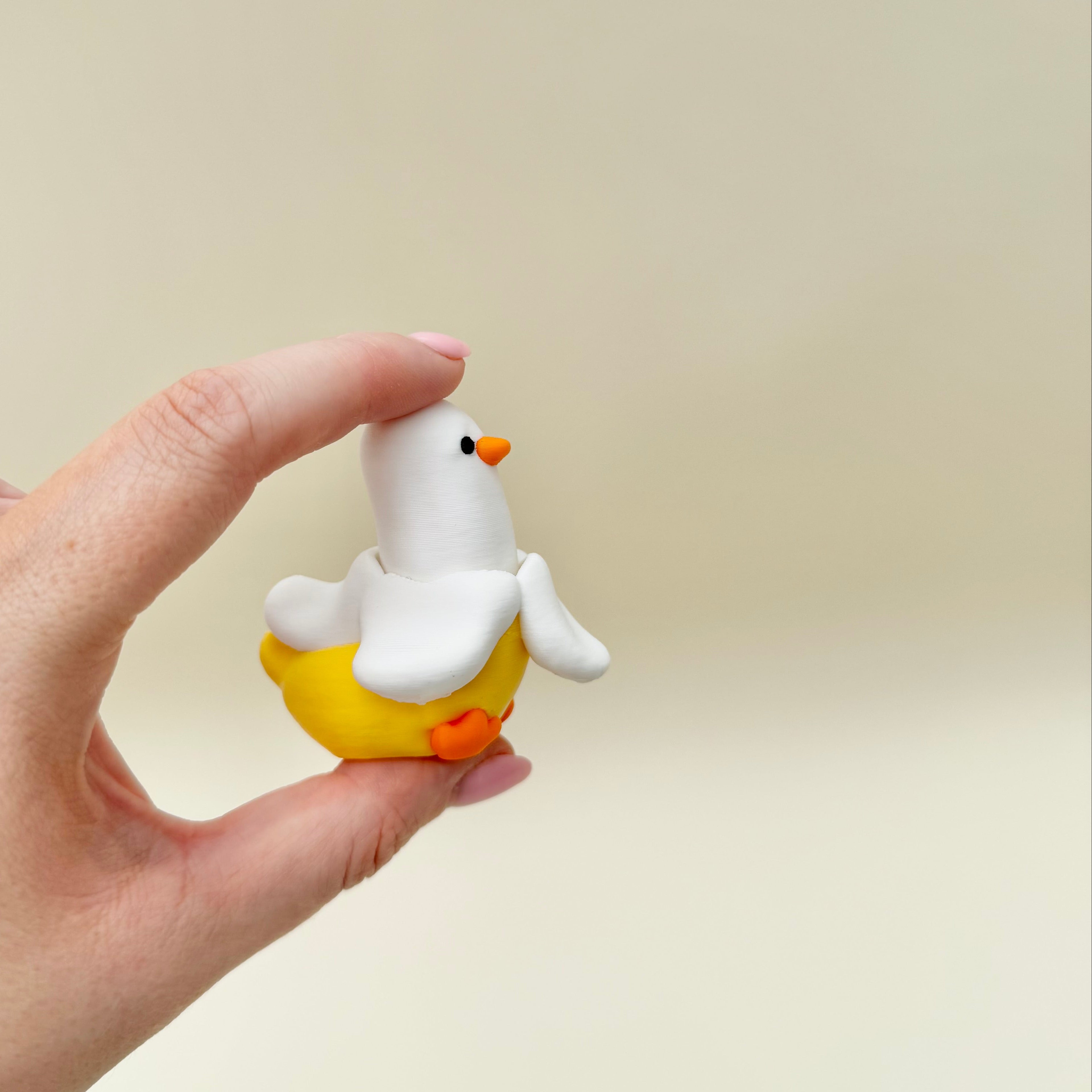 Whimsical banana duck sensory toy with a satisfying mechanical click and smooth handheld design.
