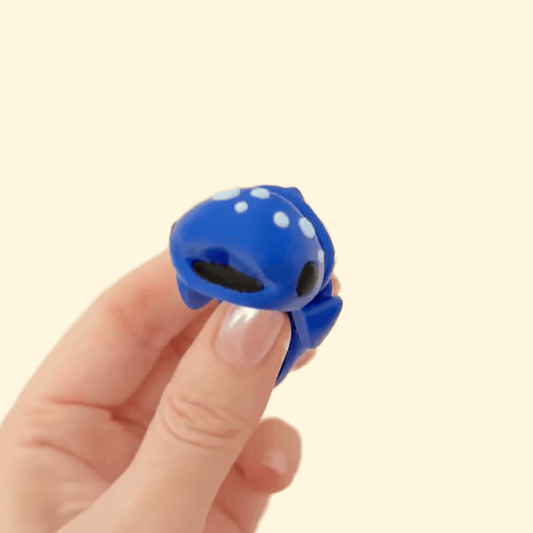 Compact whale shark fidget toy with detailed articulation, dark blue body, and light blue spot design.