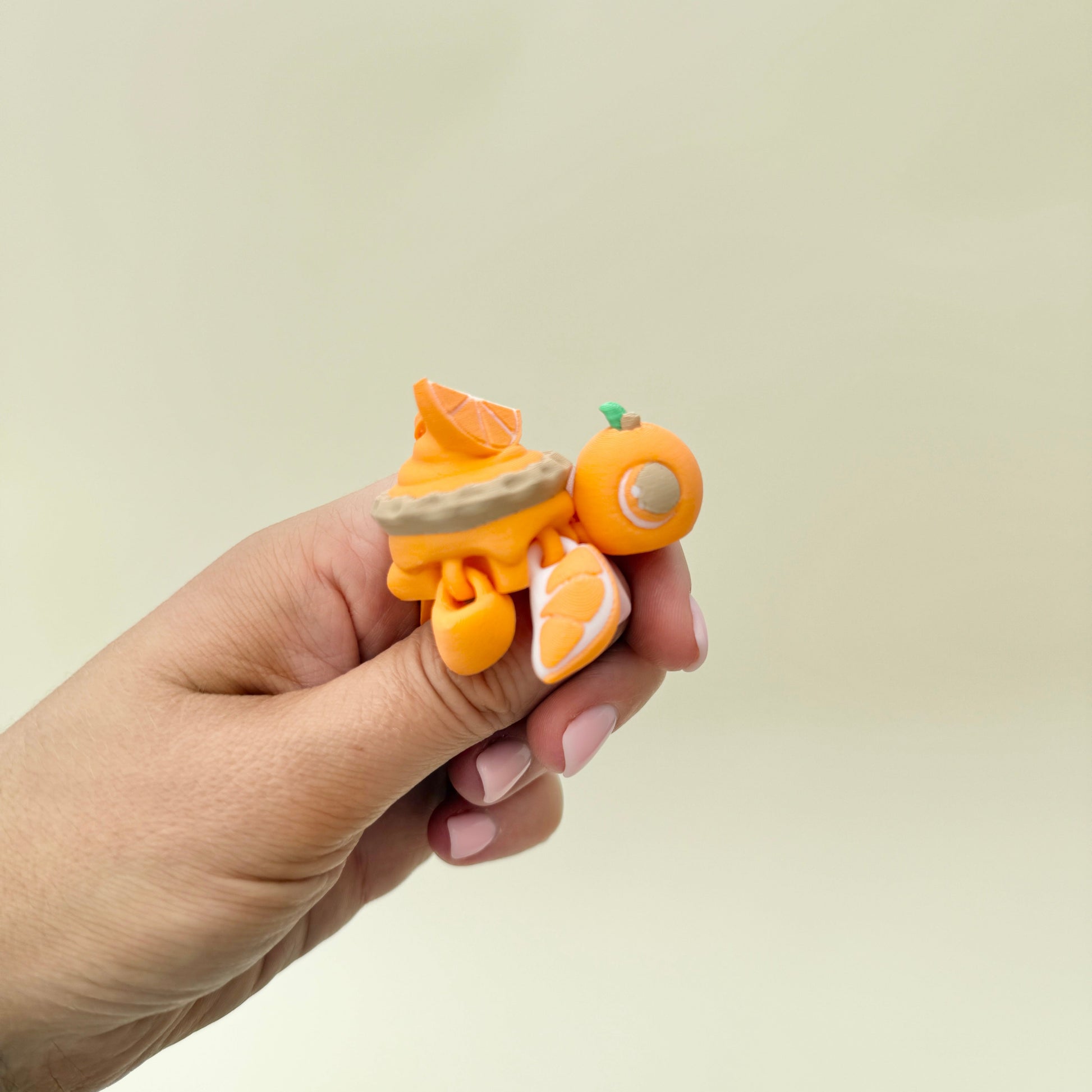Mini turtle fidget with an orange slice tart shell and moving head and legs.
