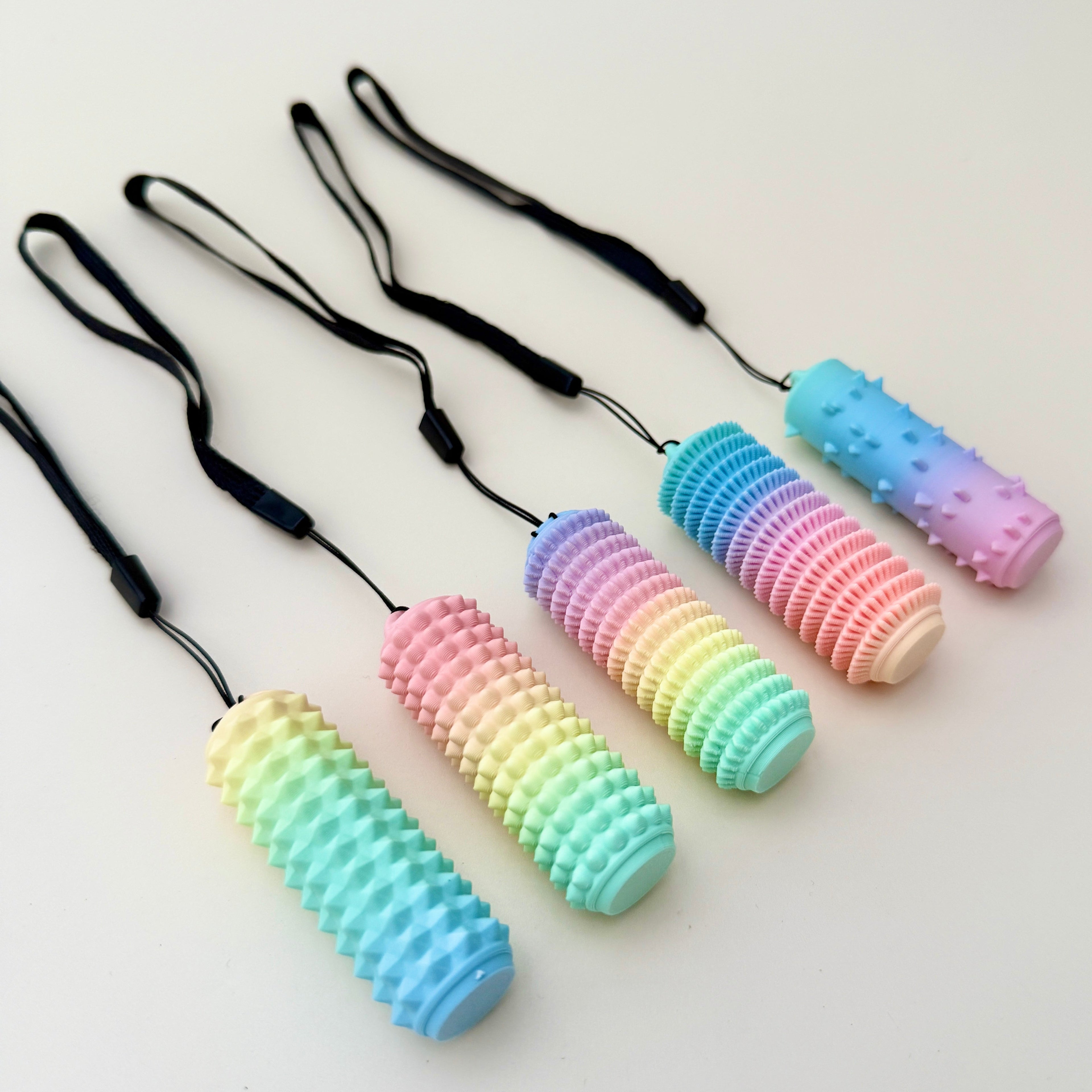 A matte rainbow tactile stim fidget designed for grounding, pain stimming, and sensory use.