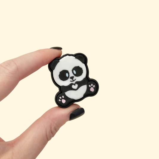 Small flat panda fidget clicker, black and white, smooth press front, pocket sized for on-the-go stimming.