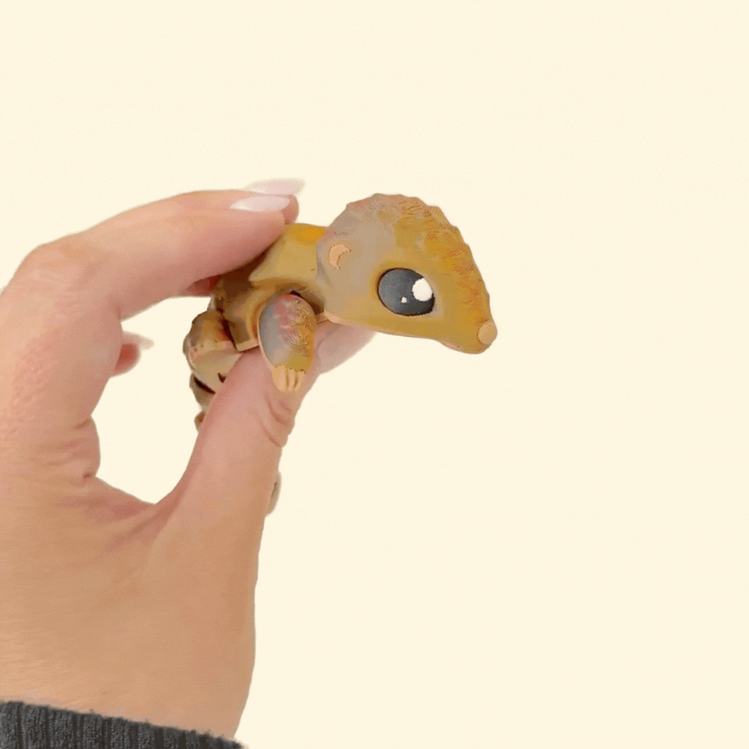 Adorable articulated pangolin sensory toy, textured and colour-changing from brown to deep reddish tones