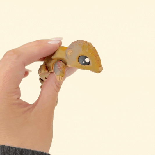 Adorable articulated pangolin sensory toy, textured and colour-changing from brown to deep reddish tones