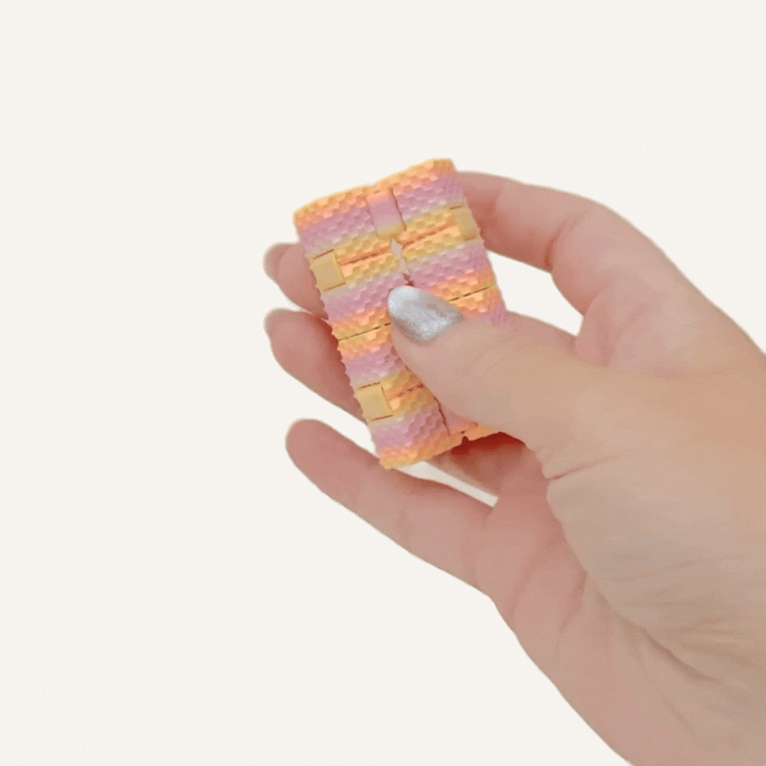 Handheld textured cube fidget for calming, grounding and everyday stimming on the go.
