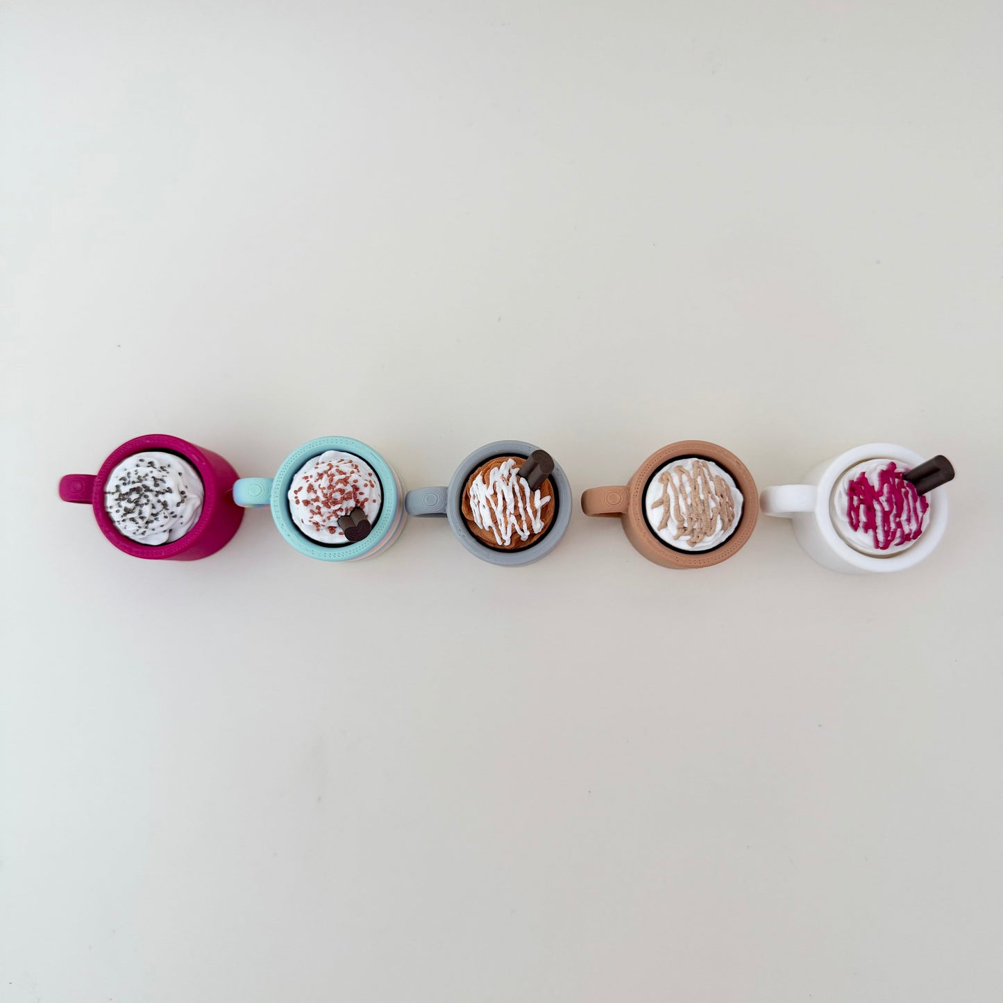 Small rainbow cup fidget with whipped top; available in click or quiet versions.
