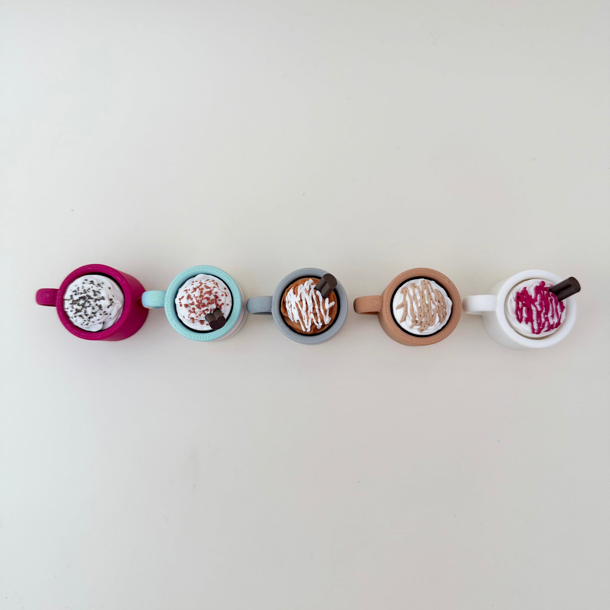 Small rainbow cup fidget with whipped top; available in click or quiet versions.
