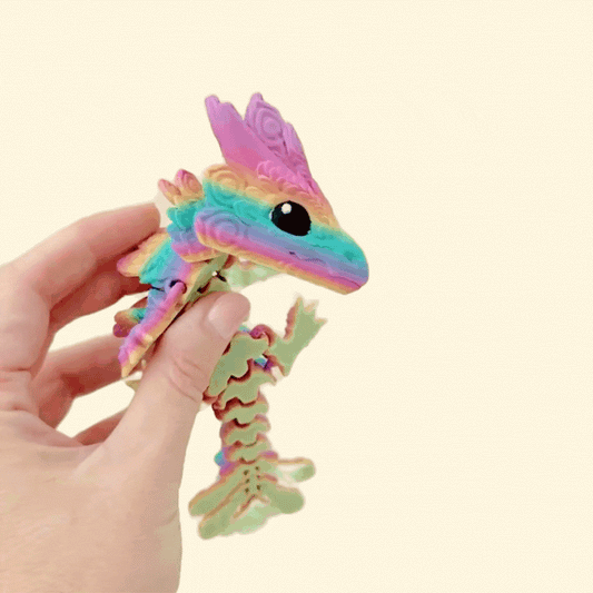 Articulated dragon with tail and crest shaped like feathers, made for sensory use.