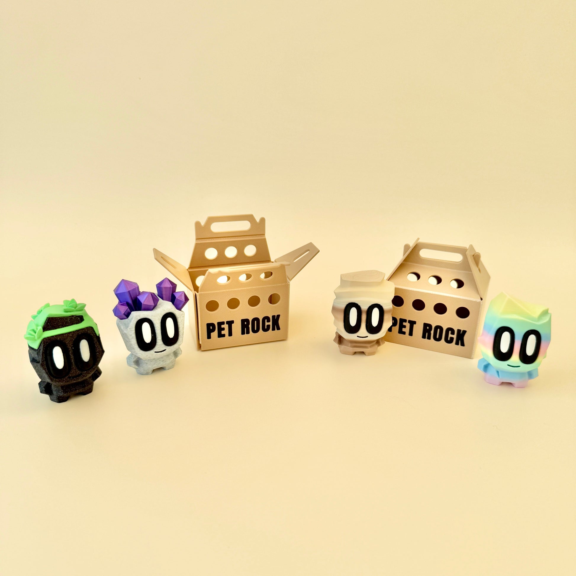 A cute pet rock toy with big eyes, a smile, and a carry box, perfect for collecting and fidgeting.