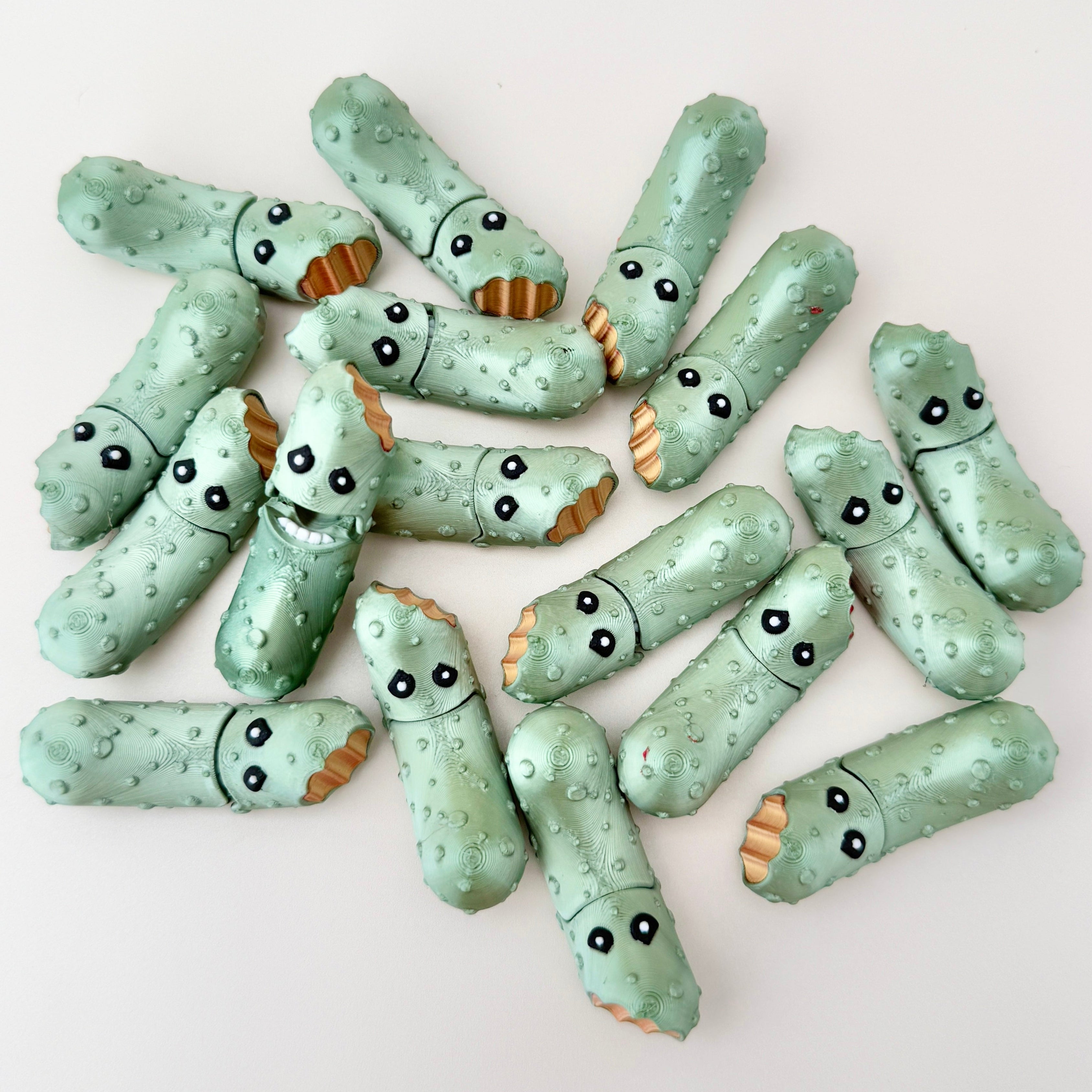 A fun and quirky fidget toy shaped like a metallic green pickle, ideal for pickle lovers and collectors.