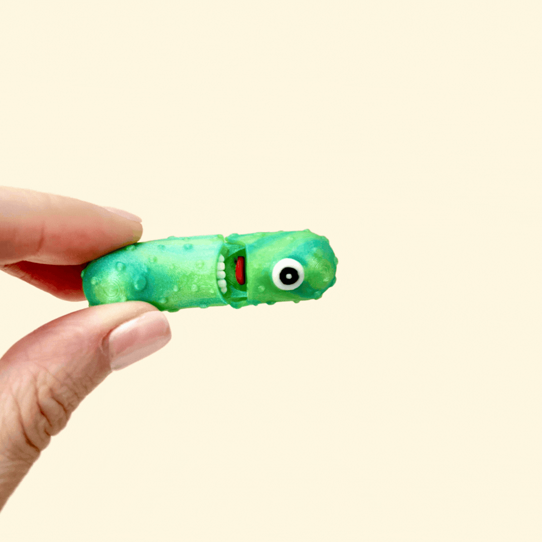 Sparkly green pickle fidget toy with a cyclops eye, perfect for pickle lovers.